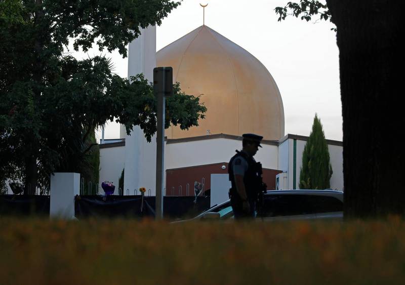FILE - In this March 17, 2019, file photo, a police officer stands guard in front of the Al Noor mosque in Christchurch, New Zealand. The man authorities believe carried out the Christchurch mosque attacks is due to make his second court appearance via video link on Friday, April 4, 2019, although media photographs wonâ€™t be allowed and reporting on the proceedings will be limited by New Zealand law. Fifty people died in the March 15 attacks on two mosques (AP Photo/Vincent Yu, File)
