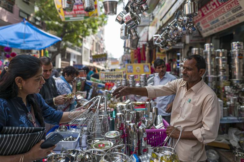 Shoppers buy stainless steel utensils at a marketplace in Noida, on the outskirts of New Delhi. Bloomberg