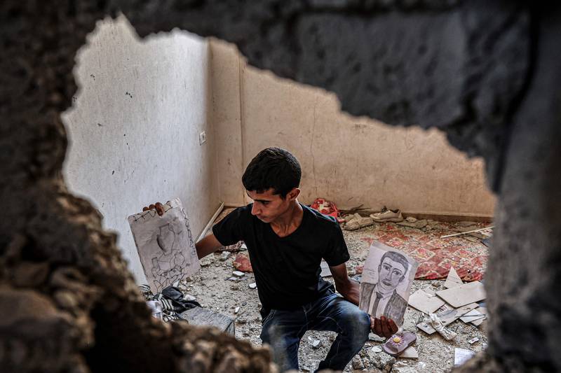 Diana al-Amour's brother inspects her sketches in her former room in the family home in the southern Gaza Strip. AFP