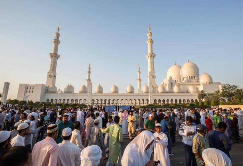 Abu Dhabi, UNITED ARAB EMIRATES - A family gathers for a photo opportunity after performing morning prayers on the first day of Eid-Al Fitr at the Sheikh Zayed Grand Mosque.  Leslie Pableo for The National