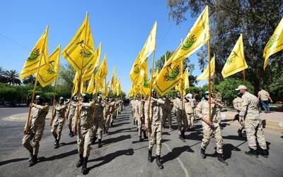 Fighters of Al Nujaba carry their flags and march during an anti-Israel rally in Baghdad, 2019.  EPA