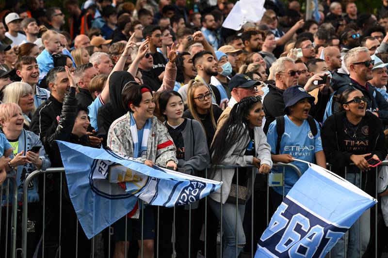 Manchester City's fans wait for the open-top bus parade to start. AFP