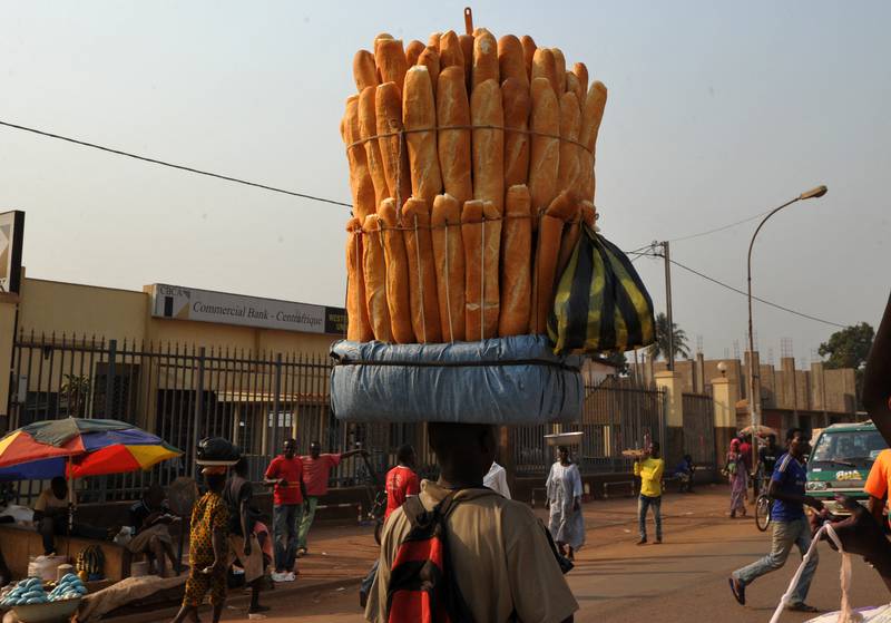 A seller carries baguettes on his head in a market at Bangui in the Central African Republic. AFP