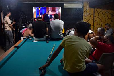 Beirut residents watch a televised interview with Saad Hariri. International donors say a government must be established before they can help Lebanon.