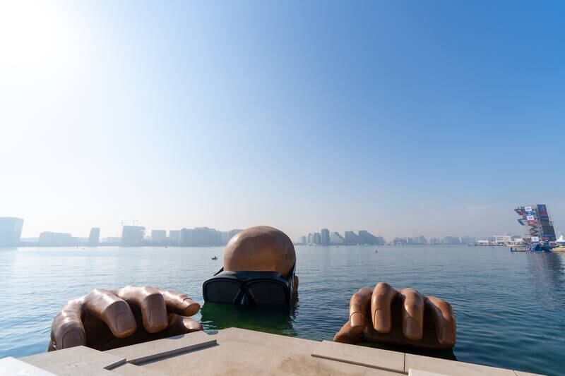 'The Emerging Man' features an eight-metre-high head and two hands in the water. Photo: Yas Bay Waterfront