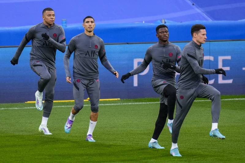 Kylian Mbappe, left, attends a training session with his teammates at the Bernabeu stadium. AP