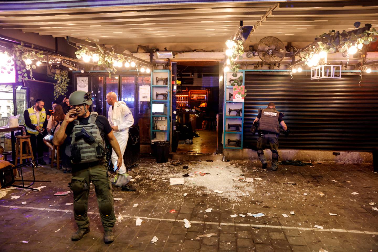 Israeli security and rescue personnel work by the entrance to a restaurant after a shooting in Tel Aviv on April 7. Reuters