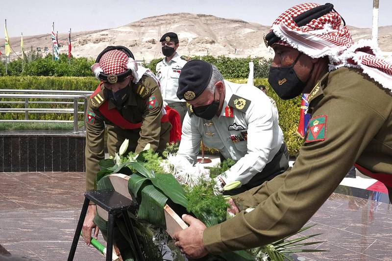 Jordan's King Abdullah, centre, lays a wreath during his visit to the war memorial in Al Karameh to commemorate the 53rd anniversary of the Battle of Karameh. AFP