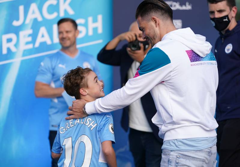 Jack Grealish with a young fan at the Etihad Stadium.