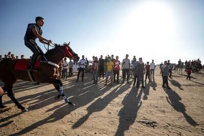 A Palestinian rides a horse during a horse race on the grounds of Yasser Arafat Airport in eastern Rafah, southern Gaza Strip, 28 June 2022.  The Yasser Arafat Airport, opened in November 1998, is not operational since December 2001 after the facility buildings were targeted by Israeli airstrikes, while the runway was damaged by Israeli bulldozers in 2002.   EPA / MOHAMMED SABER