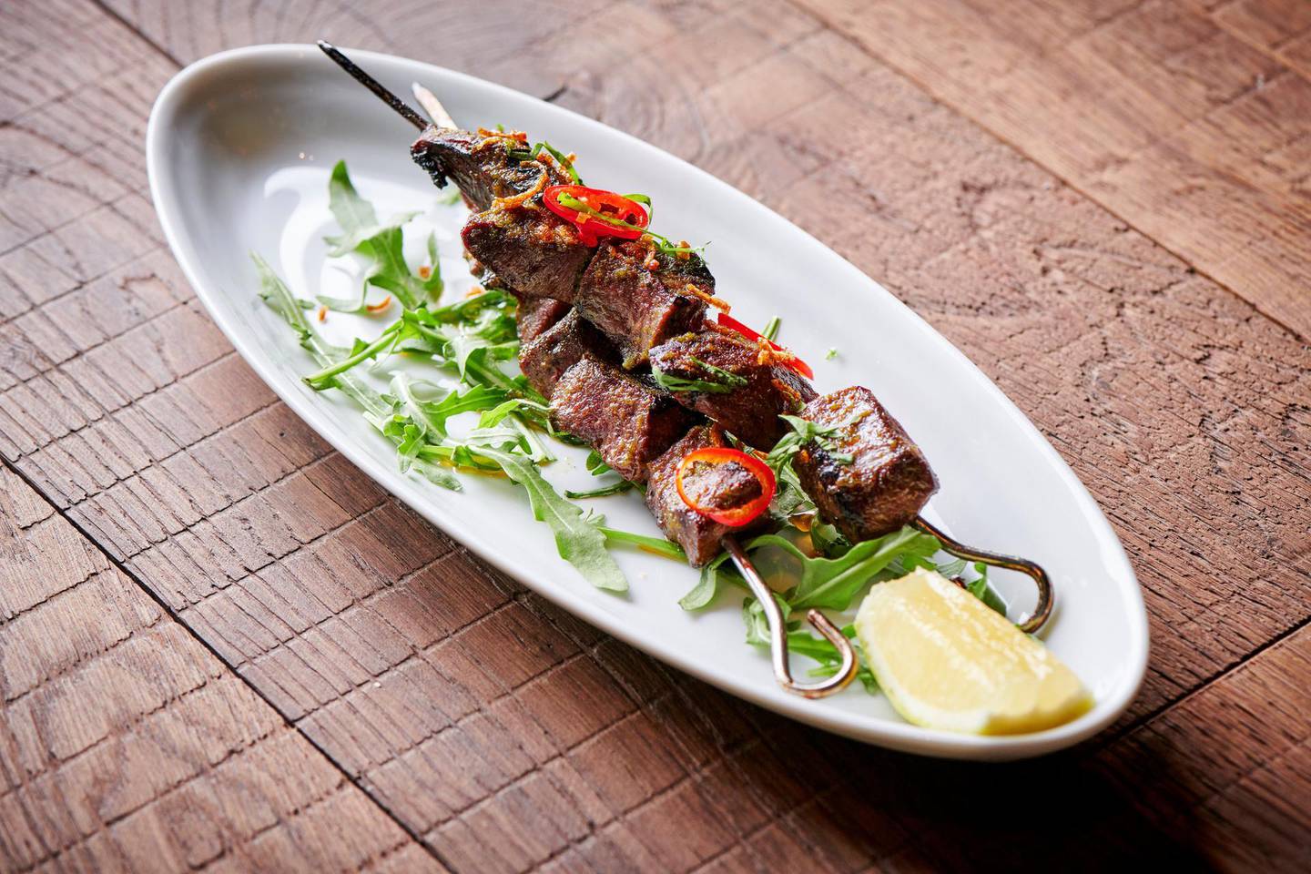 Marinated grilled beef heart skewers served at Carna by Dario Cecchini.