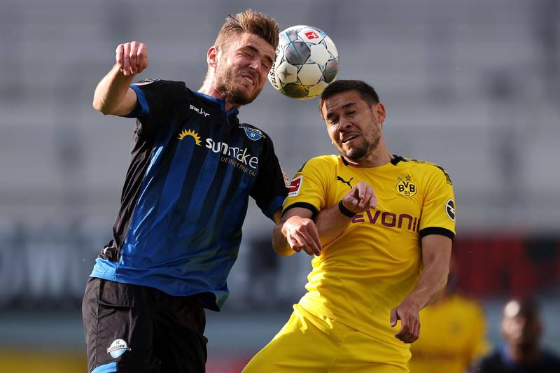 Dennis Srbeny, left, of SC Paderborn battles for the ball with Raphael Guerreiro of Borussia Dortmund. EPA