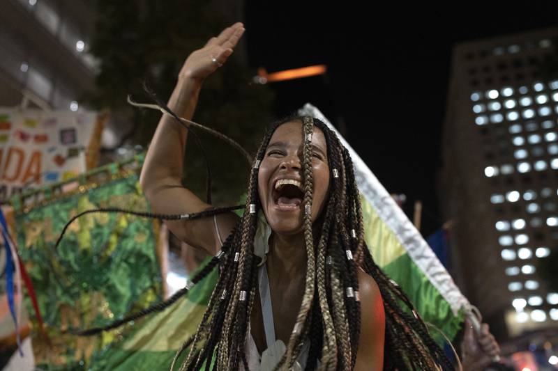 A reveller at a street party during a protest against restrictions by city officials in Rio de Janeiro, Brazil.  City Hall banned the street parties during carnival celebrations, which were delayed by almost two months because of the pandemic.  AP