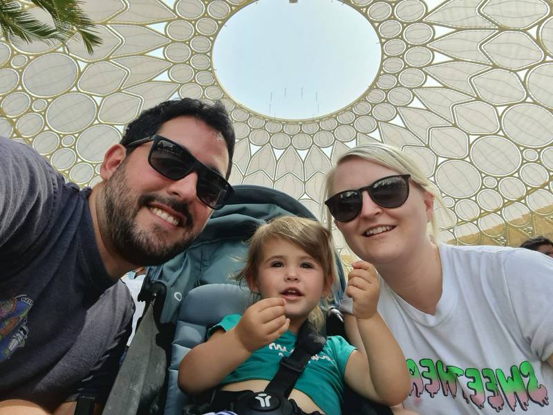 Katy Gillett, right, with her husband and daughter, aged 20 months, under Al Wasl Plaza's dome. Katy Gillett / The National