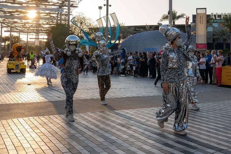 Performers dressed as silver baubles.
