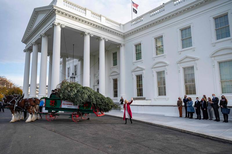 First Lady Jill Biden waves during the arrival of the White House Christmas Tree at the White House in Washington. AFP