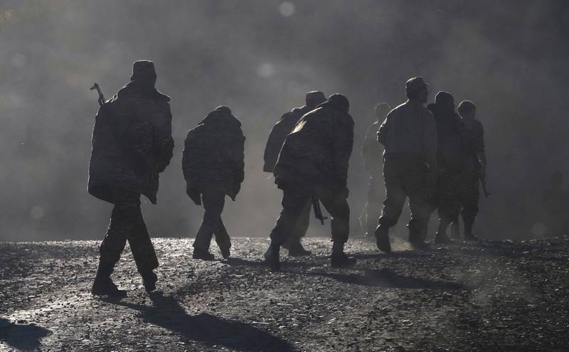 Ethnic Armenian soldiers walk along the road near the border between Nagorno-Karabakh and Armenia in November 2020. AP