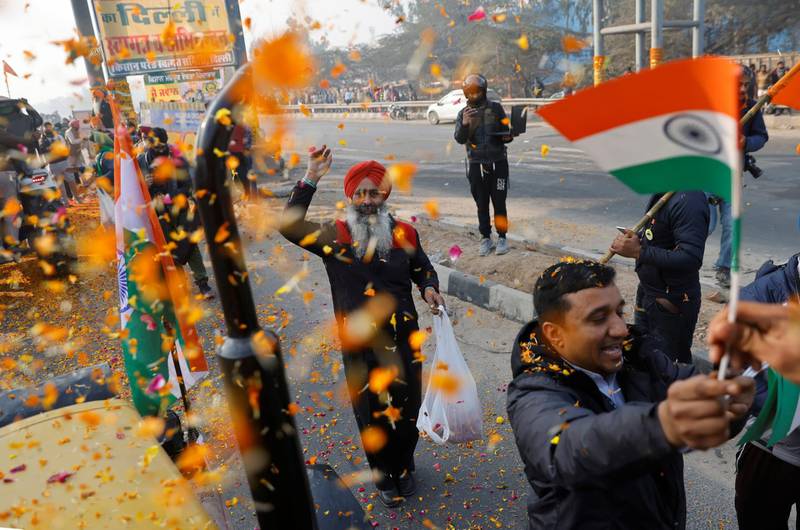 Farmers are showered with flower petals as they take part in a tractor rally to protest against farm laws on the occasion of India's Republic Day in Delhi. Reuters