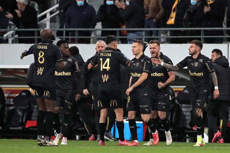 Players of Lens celebrate their 1-0 lead. EPA