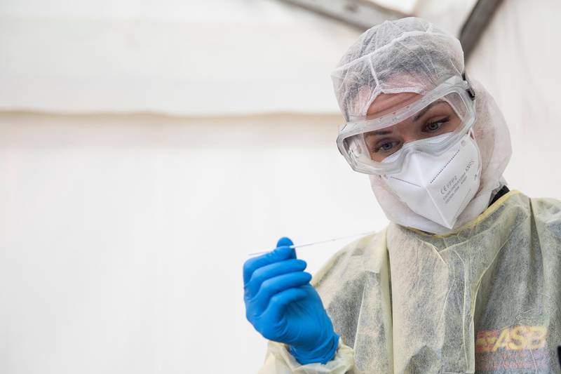 A medical worker takes a swab sample outside at a Covid-19 testing station in Berlin, Germany. Getty Images