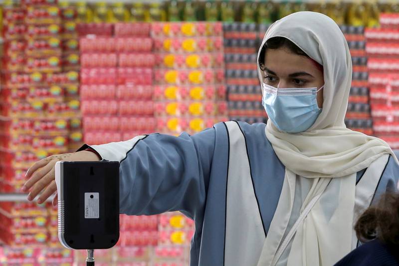 A Saudi woman measures her temperature as she enters the Al-Othaim market amid the spread of the coronavirus disease (COVID-19) in Riyadh, Saudi Arabia February 22, 2021. Picture taken February 22, 2021. REUTERS/Ahmed Yosri