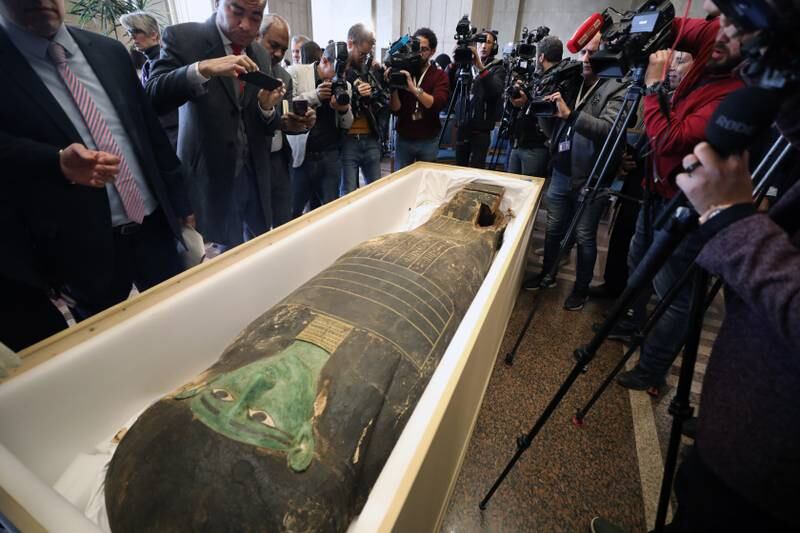 Reporters take photographs of the ancient Egyptian artefact 'Green Sarcophagus' in Cairo after it was returned from the Houston Museum of Natural Sciences. EPA