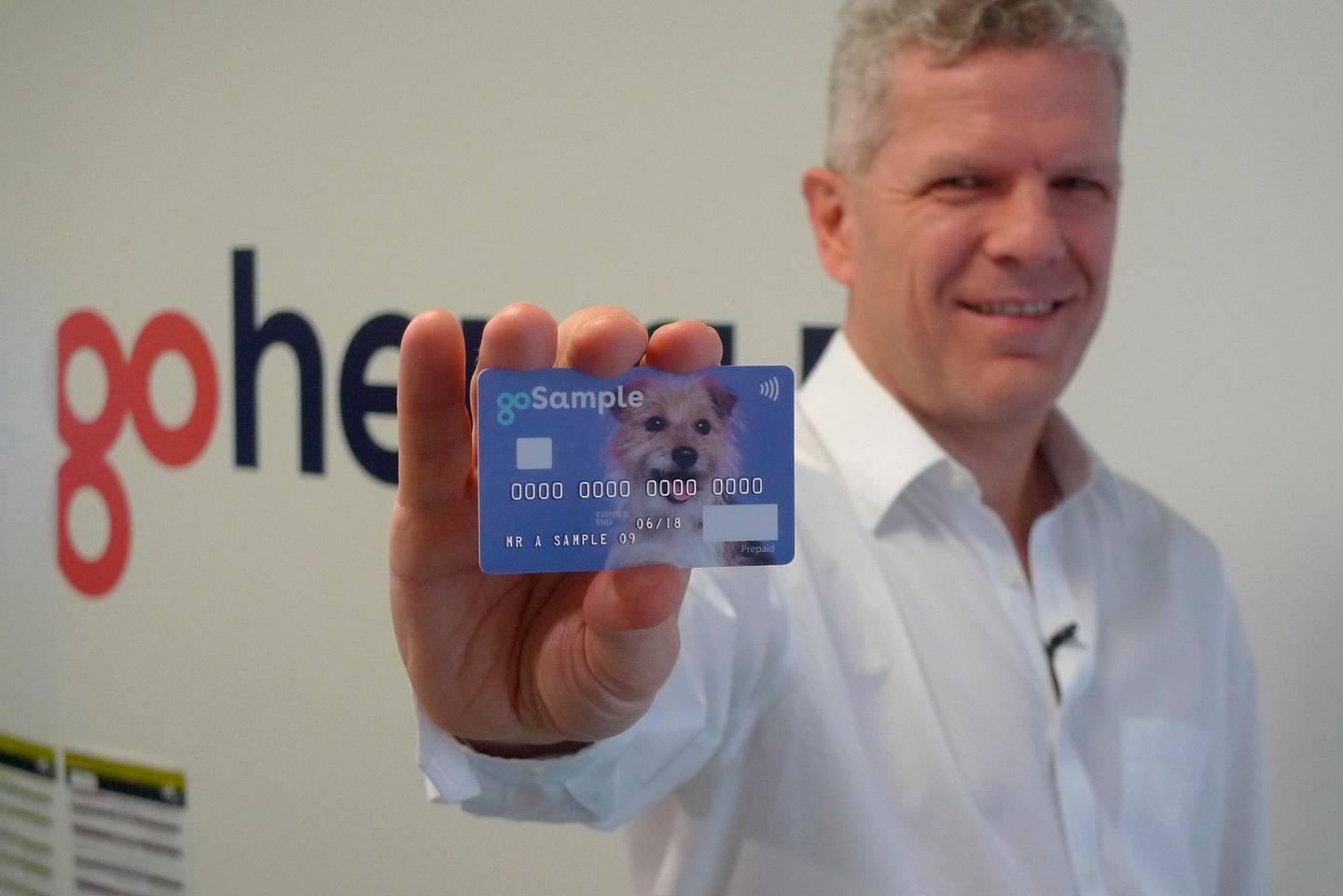 In this Oct. 17, 2018 photo, Alex Zivoder, CEO of Gohenry, a digital banking startup aimed at children, holds up a sample of the prepaid debit cards that the app comes with, in London. A wave of digital pocket money apps that come with prepaid cards are new tools for financial education as money increasingly goes digital, in a shift thatâ€™s raising uncertainty about how cashless transactions affect youngstersâ€™ view of money. (AP Photo/Kelvin Chan)