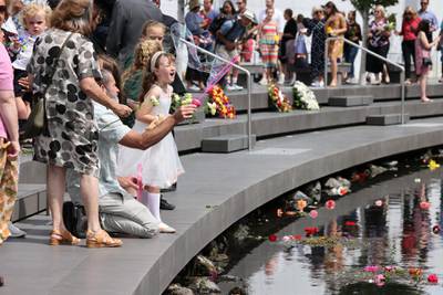 A family member of one of the 185 victims blows bubbles over the Avon River during the national memorial service. Getty Images