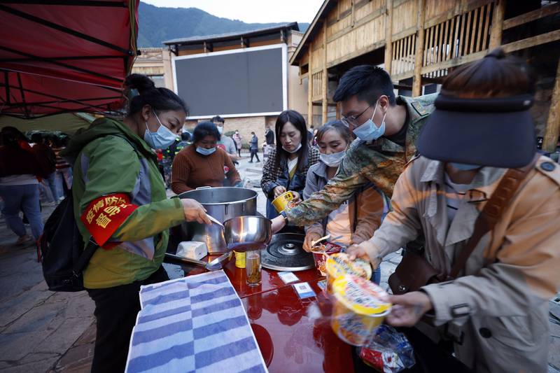 Relief supplies are distributed to residents in Moxi, a town in Luding county, after the quake. AP