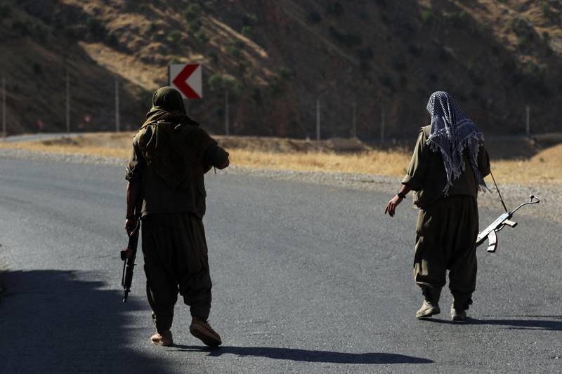 A member of the Kurdistan Workers' Party (PKK) carries an automatic rifle on a road in the Qandil Mountains, the PKK stronghold in northern Iraq. AFP