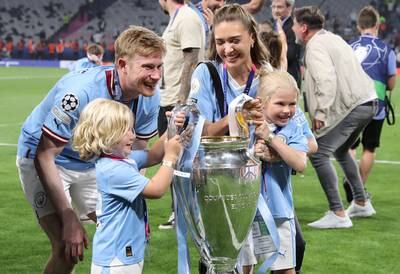 Manchester City player Kevin de Bruyne, his wife Michele de Bruyne and two of their children pose with the trophy after the team won the UEFA Champions League Final soccer match between Manchester City and Inter Milan. EPA