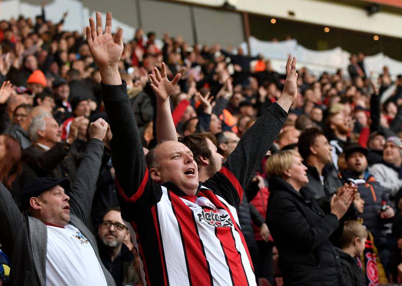 Fans of Sheffield United celebrate the result that secured their promotion. Getty