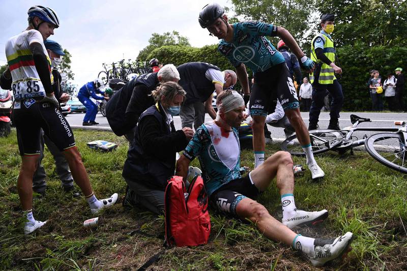 Team B&B KTM's Cyril Lemoine is helped by medical staff after crashing during the first stage of the Tour de France.