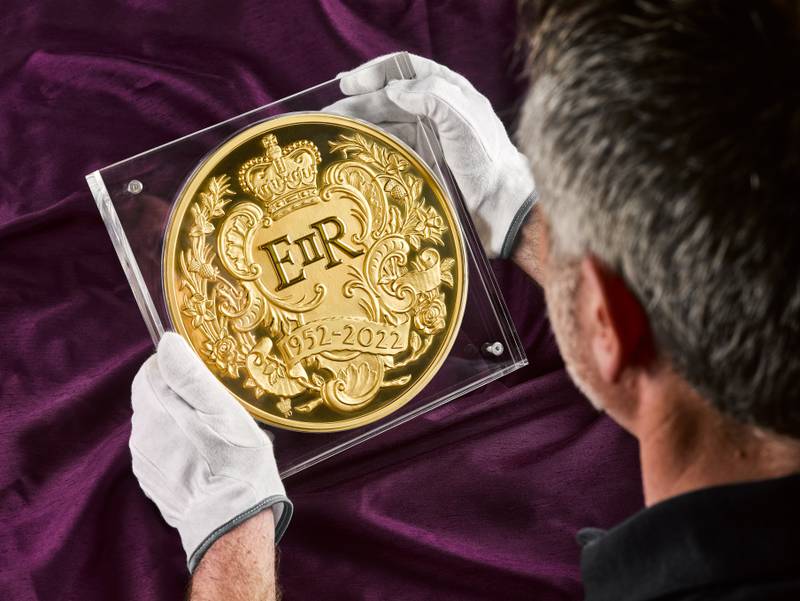 The 15-kilogram Queen's Platinum Jubilee coin, made with fine gold, is the largest coin made by the Royal Mint, produced in celebration of her 70-year milestone. PA