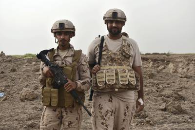 Two Emirati soldiers, part of an Arab Coalition minesweeping team, pose for a photos as they await the controlled demolition of a Houth landmine cache near Al Mokha, Yemen. Gareth Browne / The National