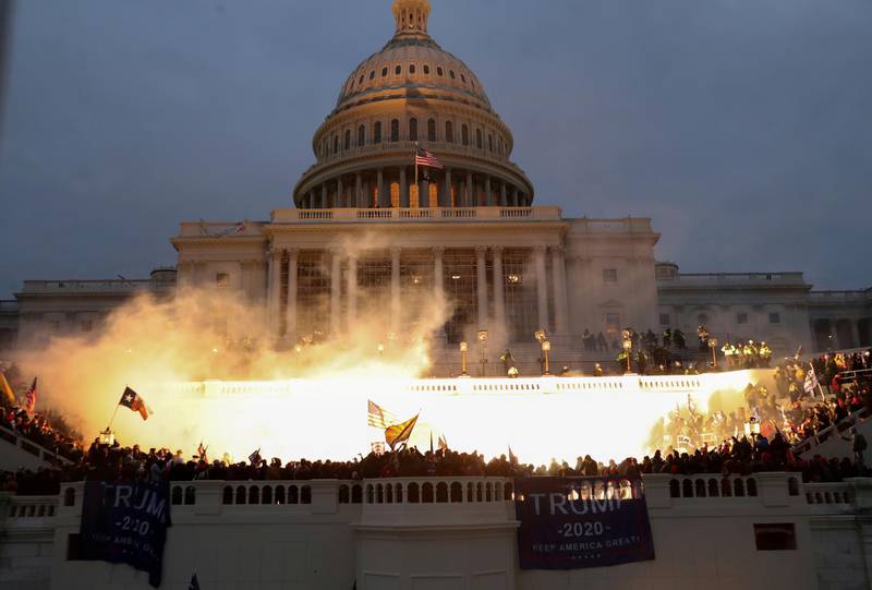 An explosion caused by a police munition is seen while supporters of US President Donald Trump gather in front of the US Capitol Building in Washington, DC, on January 6, 2021. Reuters