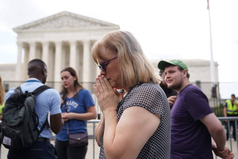 A pro-life supporter reacts outside the Supreme Court. AFP