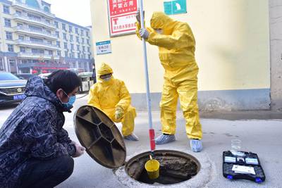 Workers of the ecology and environment bureau collect samples from the sewage system of a hospital following an outbreak of the novel coronavirus in the country, in Xinle, Hebei province, China. REUTERS