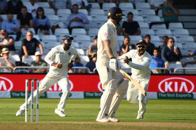India's Lokesh Rahul (L) and India's captain Virat Kohli (R) celebrate the wicket of England's Ben Stokes (C) for 62 during the fourth day of the third Test cricket match between England and India at Trent Bridge in Nottingham, central England on August 21, 2018. (Photo by Paul ELLIS / AFP) / RESTRICTED TO EDITORIAL USE. NO ASSOCIATION WITH DIRECT COMPETITOR OF SPONSOR, PARTNER, OR SUPPLIER OF THE ECB