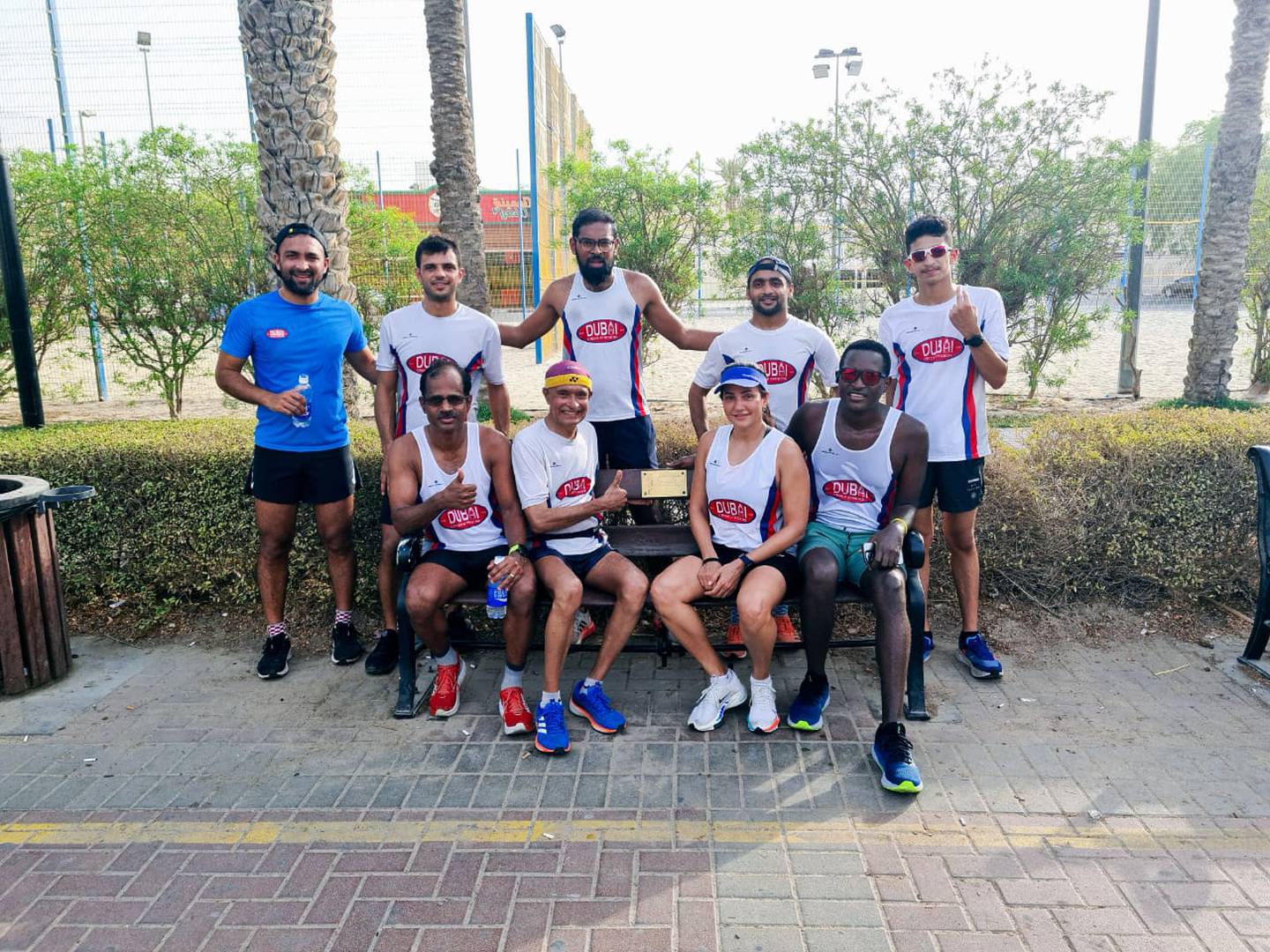Michael Lobo and other Dubai Creek Striders members on Murphy's Bench, which was erected in honour of club founder Malcolm Murphy. Photo: Michael Lobo