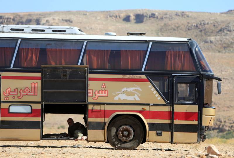 A bus driver takes a rest in Jroud Arsal, Syria-Lebanon border, August 1, 2017. REUTERS/Ali Hashisho