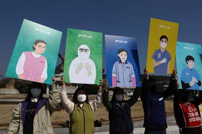 South Korean activists hold up portraits depicting the roles of female workers during a protest to mark International Women's Day in Seoul. The protesters called for an equal society free from institutional discrimination so that women can enjoy equal rights and live with dignity and pride, and build a democratic society where everyone's political, economic, social and cultural rights are fully guaranteed. Getty Images