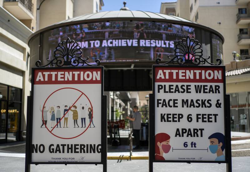 Signs with social distancing guidelines and facemask requirements are posted at an outdoor mall amid the Covid-19 pandemic in Los Angeles. AP