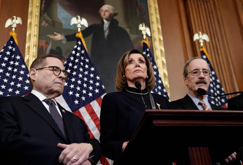Speaker of the House Nancy Pelosi, flanked by House Judiciary Committee Chairman Jerrold Nadler, left, and House Foreign Affairs Committee Chairman Eliot Engel, addresses reporters in Washington after the House of Representatives voted to impeach President Donald Trump. AP Photo