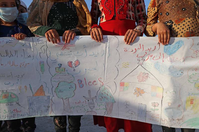 Syrian children display the banner they produced for World Peace Day.