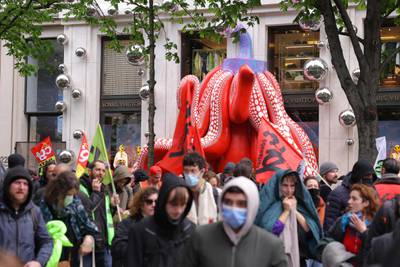 Demonstrators stand in front of the Louis Vuitton store on l'Avenue Montaigne in Paris. AFP