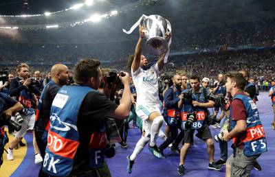 Real Madrid's Marcelo celebrates with the trophy after winning the Champions League. Matthias Schrader / AP Photo