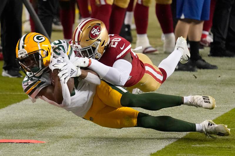Green Bay Packers running back Tyler Ervin (32) is tackled by San Francisco 49ers free safety Jimmie Ward (20) during the first half of an NFL football game in Santa Clara, California. AP Photo
