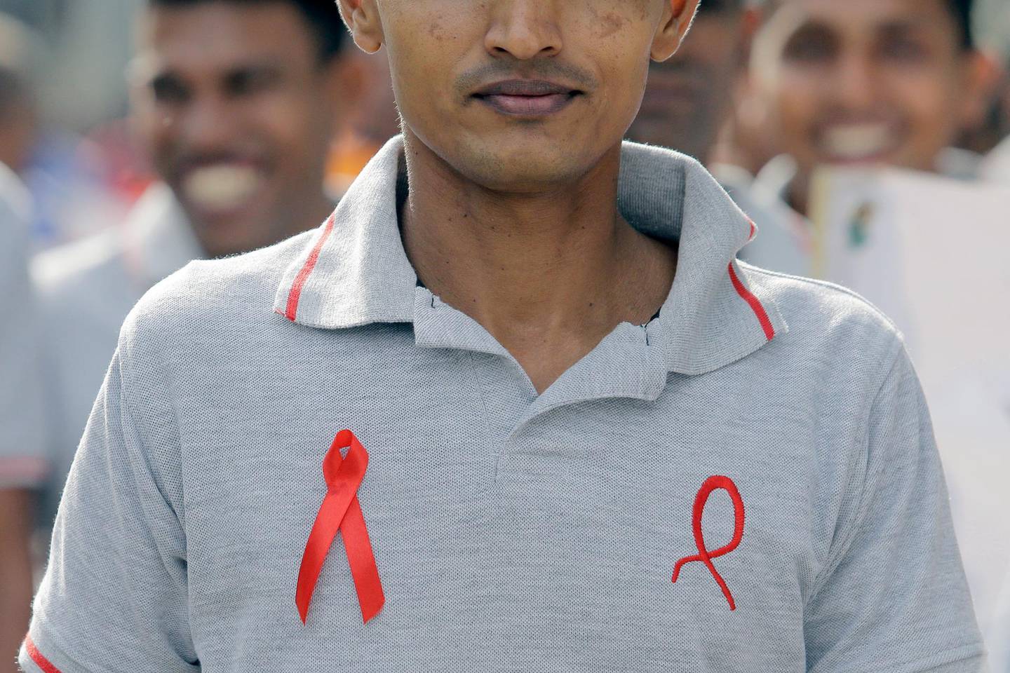 epa08034327 Sri Lankan health workers display red ribbons, an international symbol of human immunodeficiency virus infection and acquired immune deficiency syndrome (HIV/AIDS) awareness, during an AIDS awareness march in Colombo, Sri Lanka, 30 November 2019. World AIDS Day is observed every year on 01 December to raise the awareness in the fight against HIV infection.  EPA/STRINGER