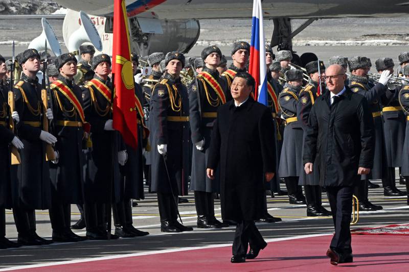 Mr Xi, accompanied by Russian Deputy Prime Minister Dmitry Chernyshenko, at a welcome ceremony at Moscow's Vnukovo Airport. AFP